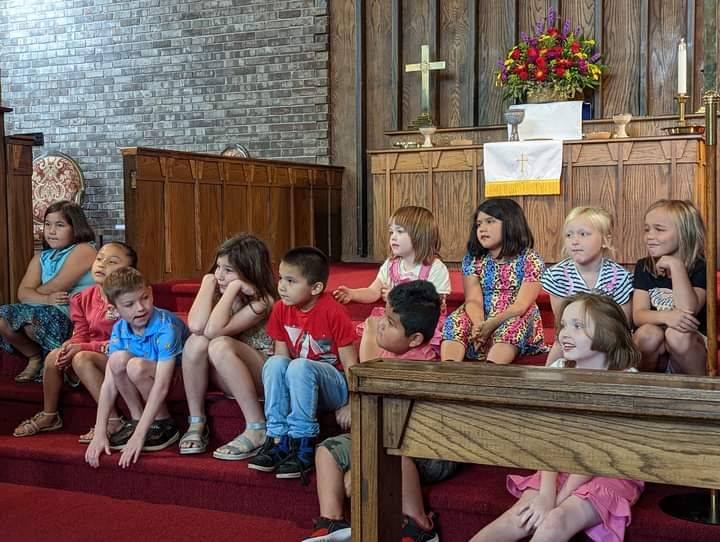 Children gathered at the front of the sanctuary
